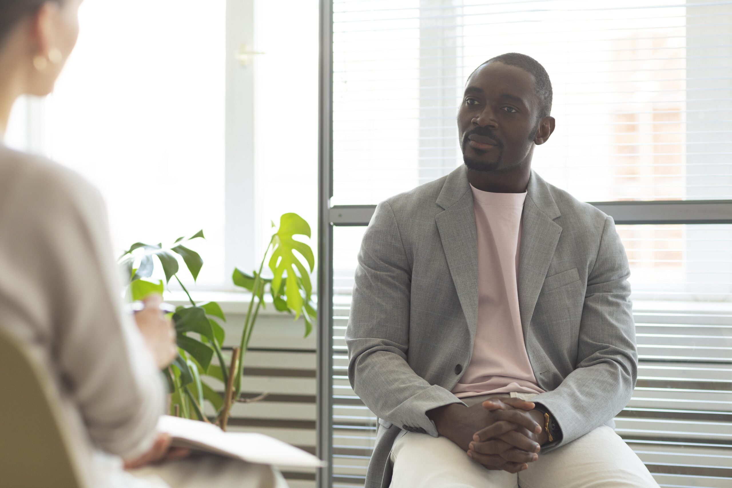 man-being-interviewed-indoors-by-journalist